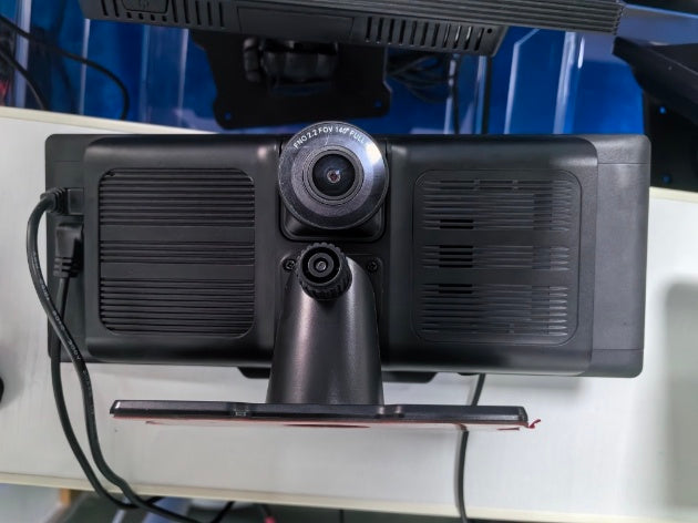 Camera mounted on a stand with a blue background