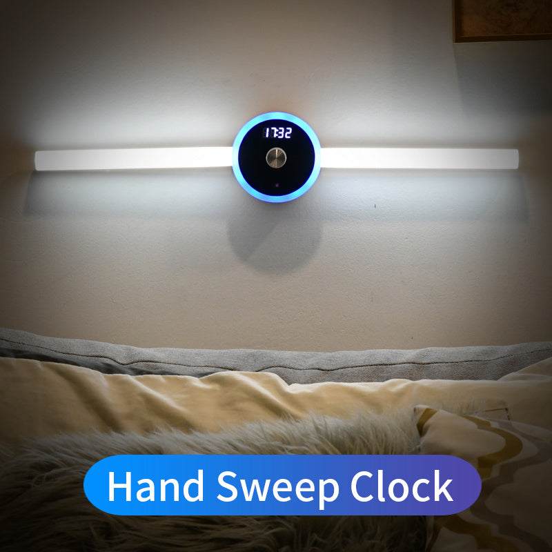 Hand Sweep Clock on a wall above a bed with a blue label